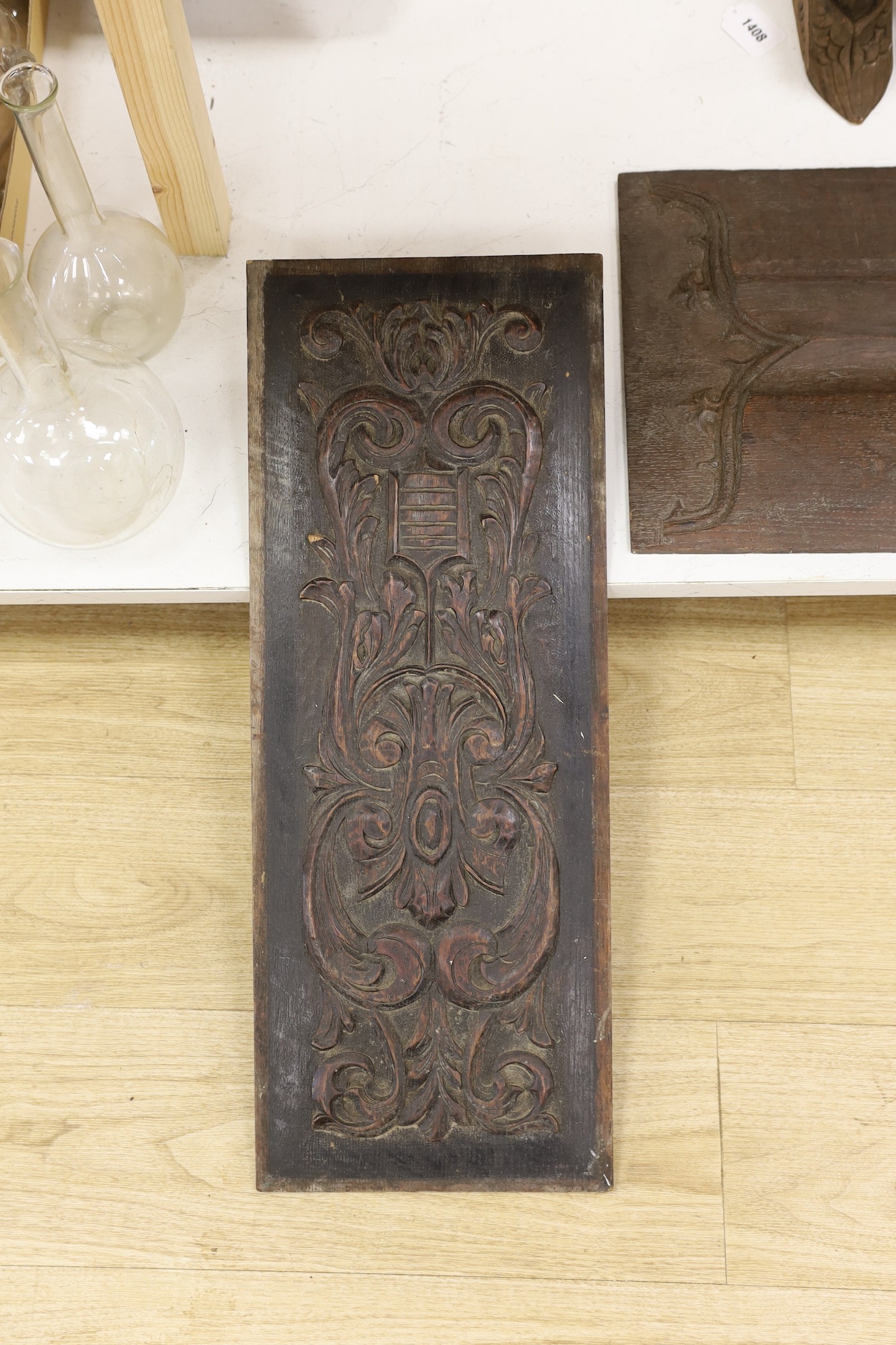 Three carved oak panels and a pair of brackets, one linenfold oak panel carved ‘from Crowland Abbey’, 46 cm X 33 cm